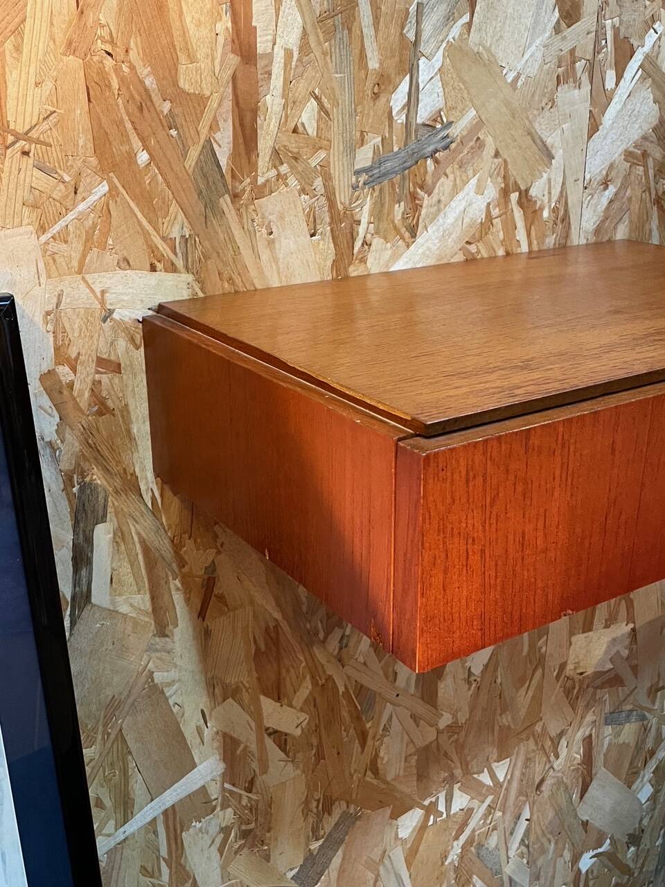 Suspended teak bedside tables in vintage 1960s Scandinavian style.