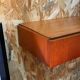 Suspended teak bedside tables in vintage 1960s Scandinavian style.