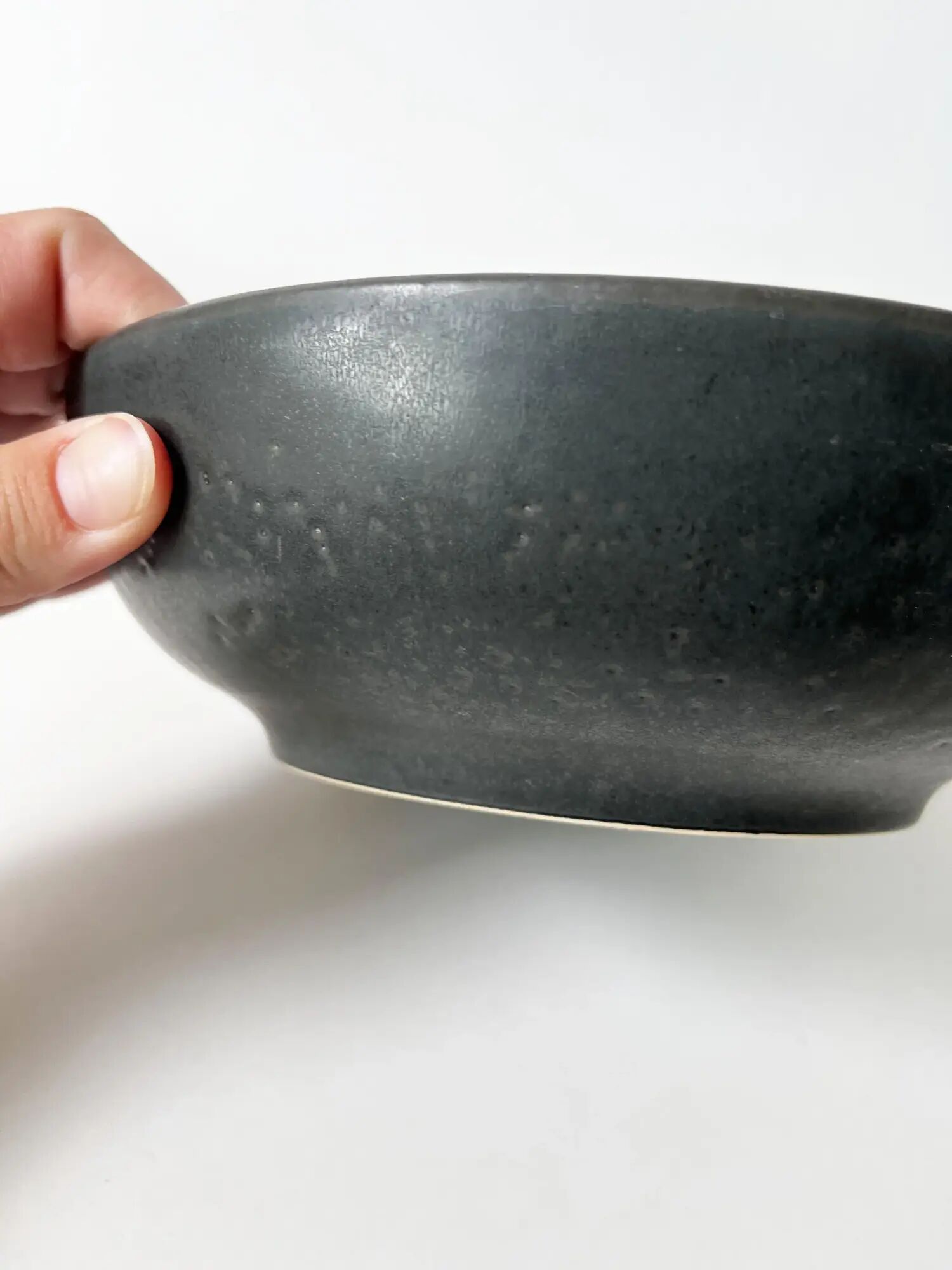 Round vintage black ceramic catchall.