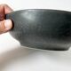 Round vintage black ceramic catchall.