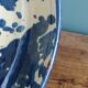 Empty pocket bowl in terracotta, glazed with "ink spots" design.