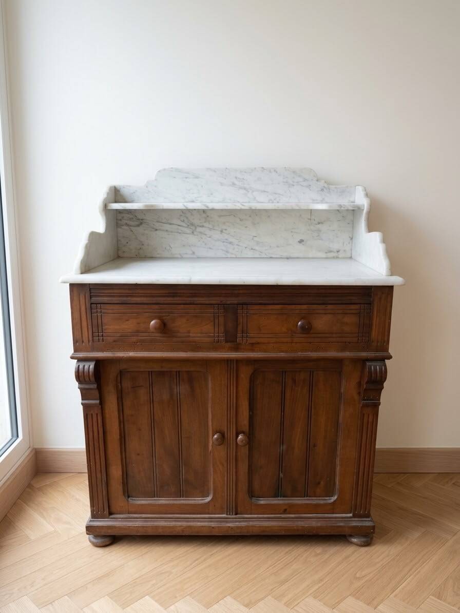 Antique wooden chest of drawers with a marble top.