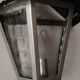 Half grey metal wall sconce and 3 windows