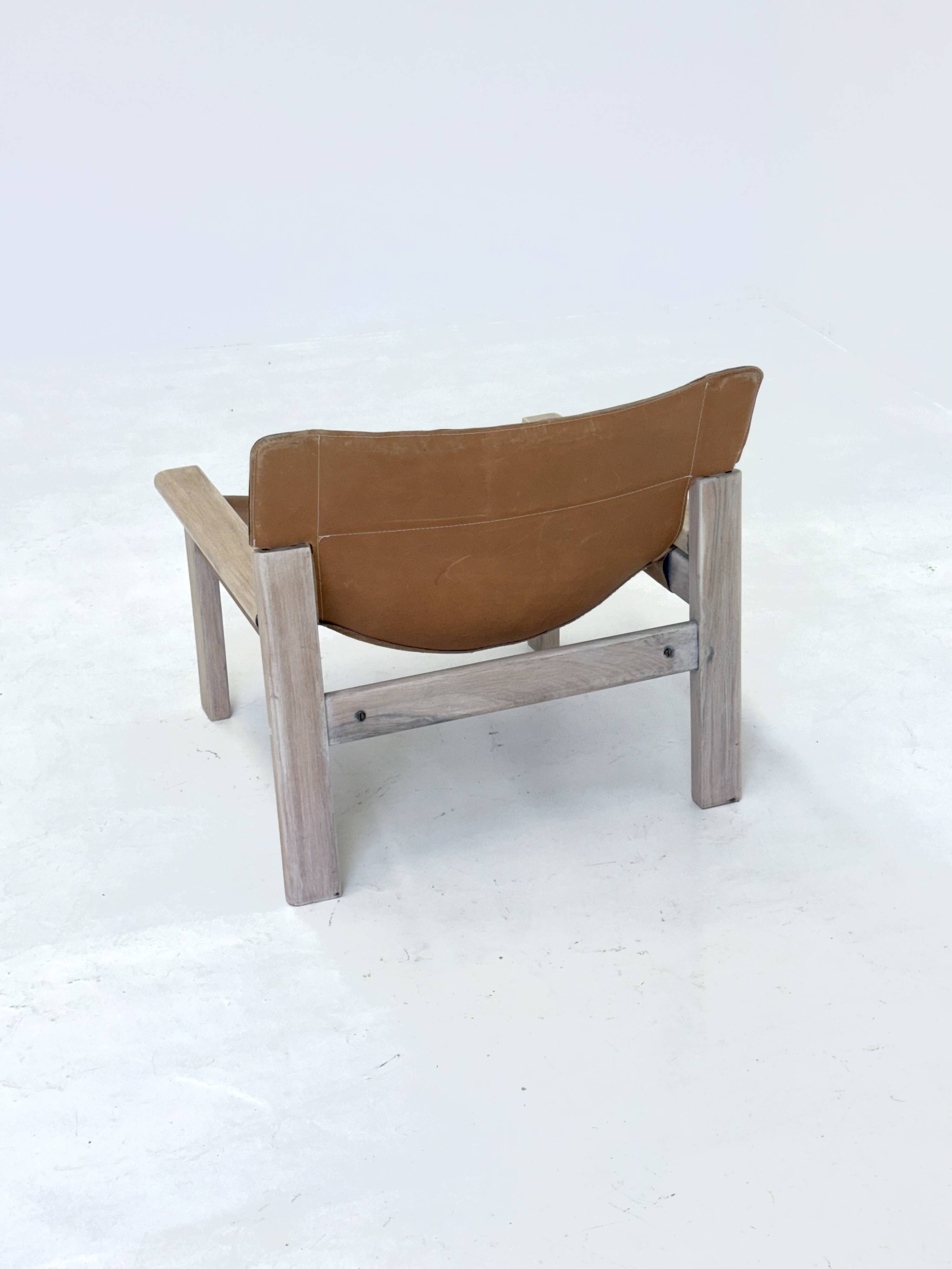 Stylish vintage armchair with saddle leather seat