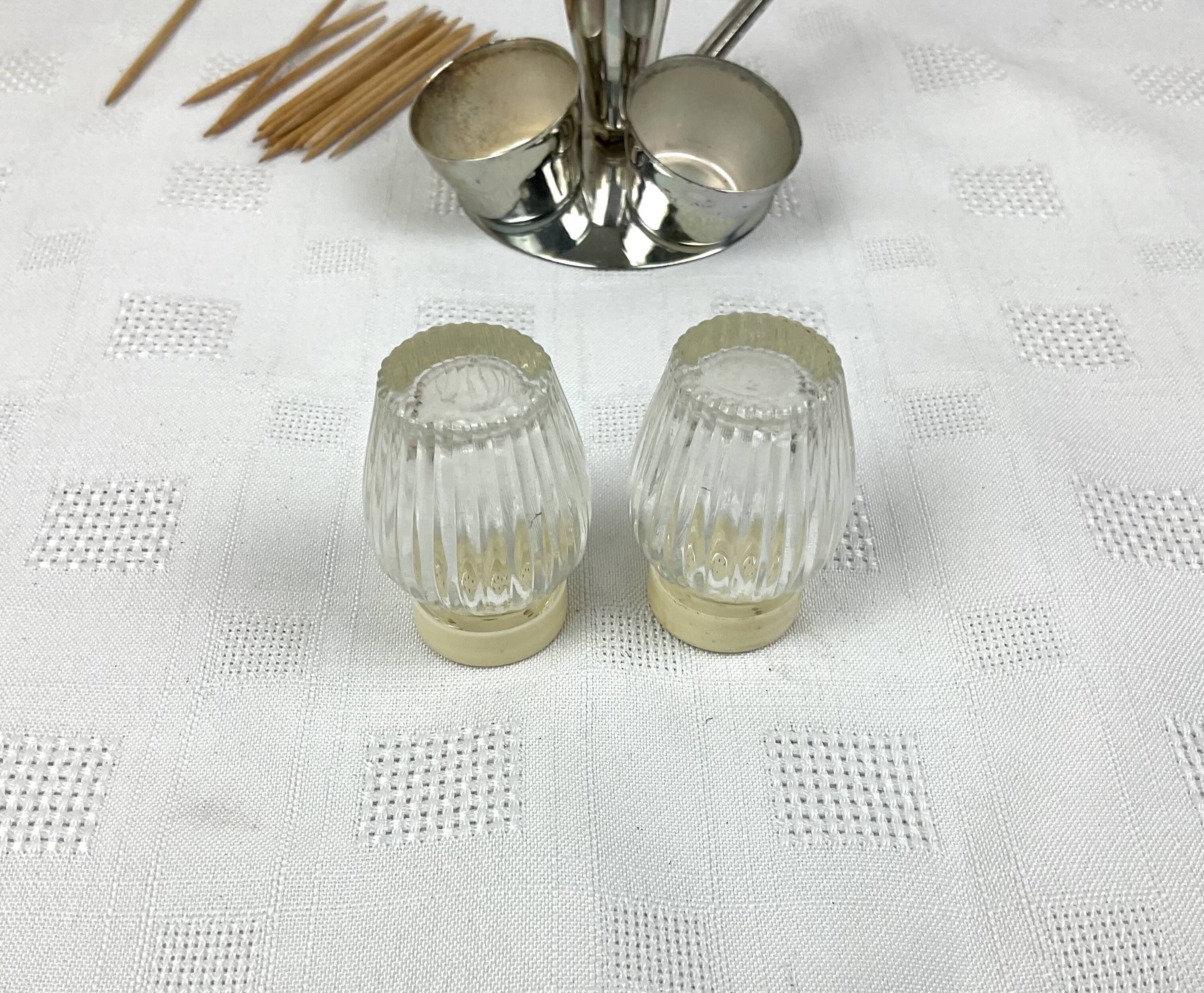 Vintage salt and pepper shakers and their chrome metal support