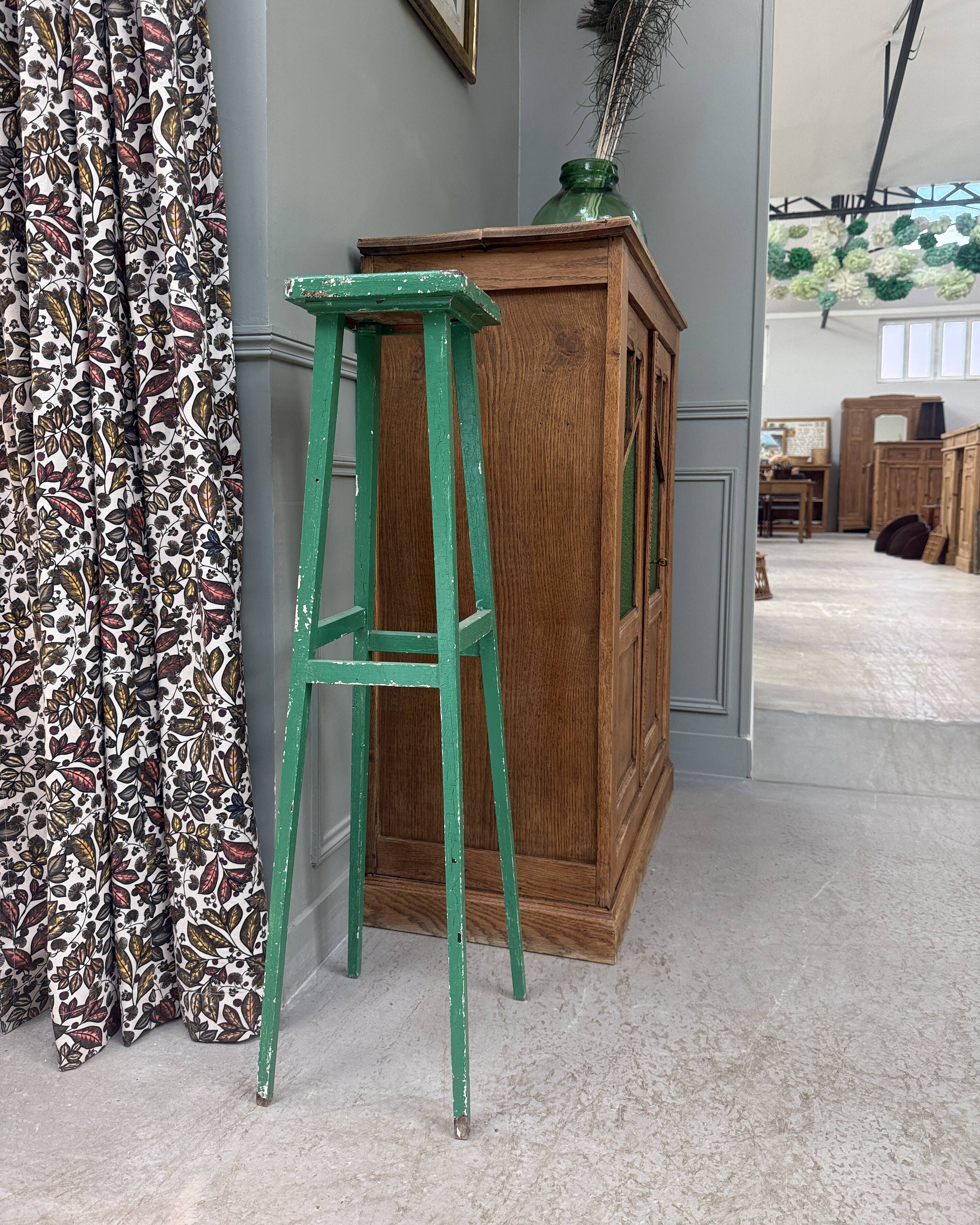 Vintage wooden stool with green patina.
