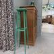 Vintage wooden stool with green patina.