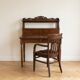 Old wooden tiered desk and its matching chair.