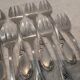 12 silver-plated oyster forks with rocaille ribbon decoration, 13.7 cm