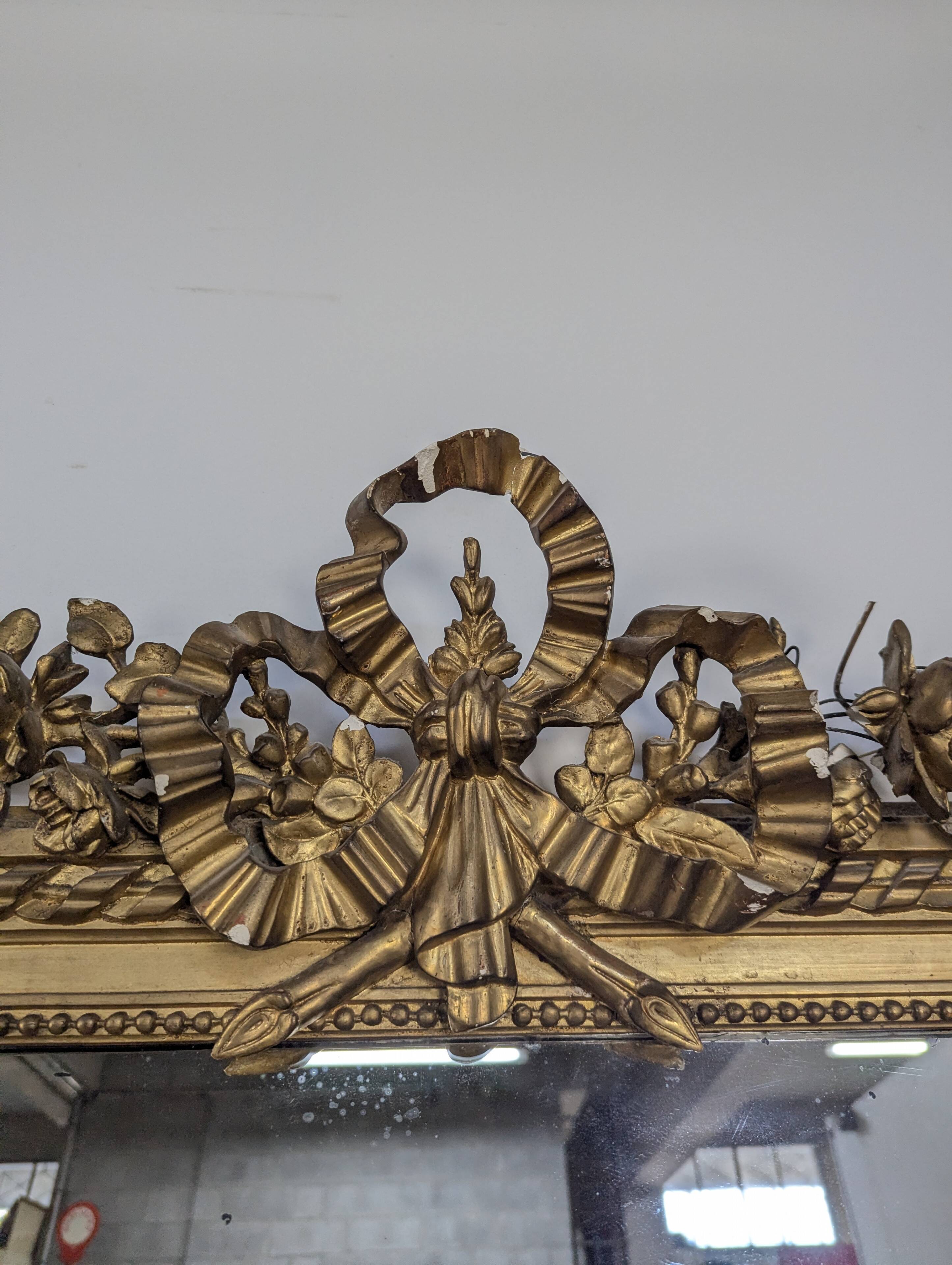 Golden Louis XVI style mirror with bouquet and shells.