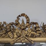 Golden Louis XVI style mirror with bouquet and shells.