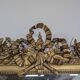 Golden Louis XVI style mirror with bouquet and shells.