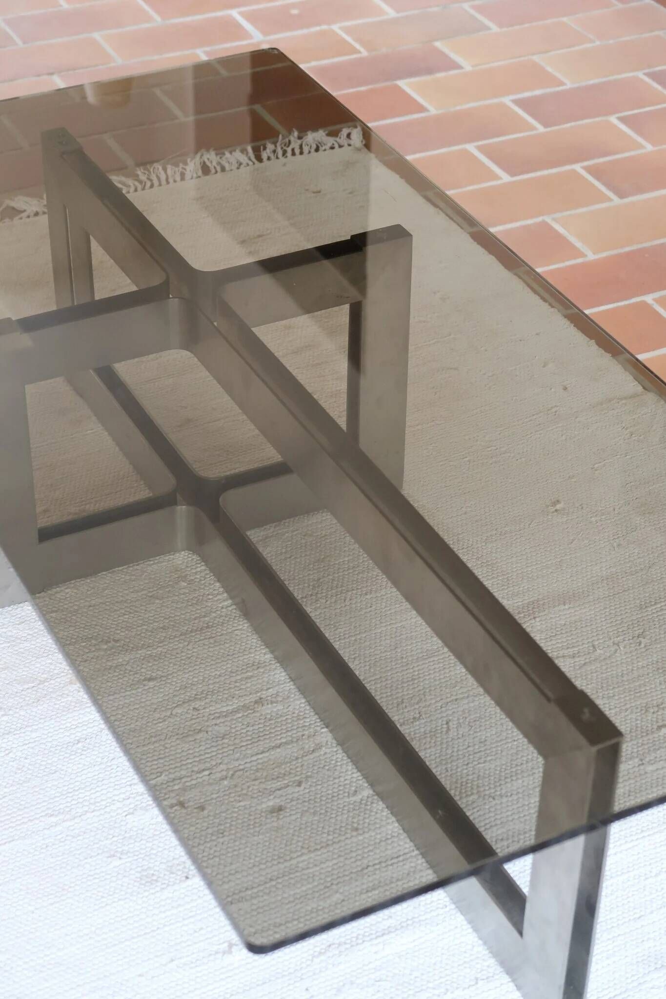 Smoked glass coffee table, brushed stainless steel base, 1970s.