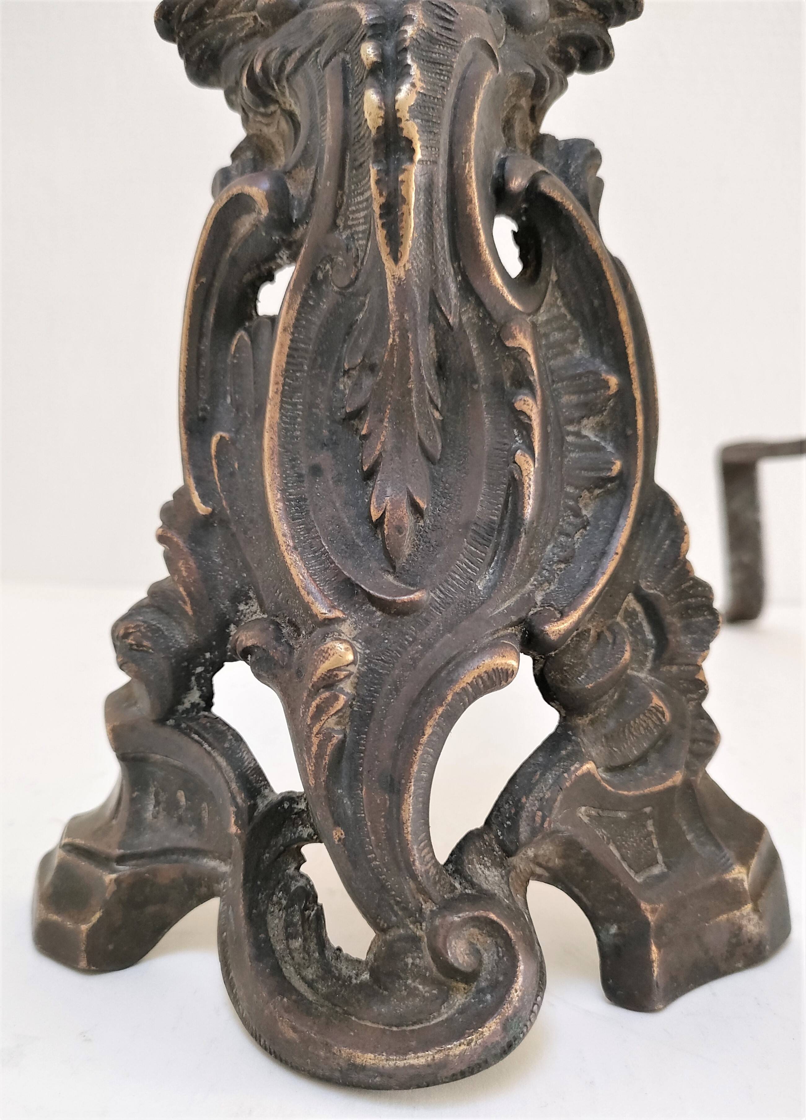 Pair of bronze andirons with black patina, 19th century, female caryatids
