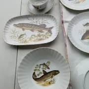 vintage porcelain dinner service with fish pattern and gold trim