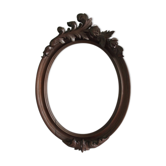 Wooden oval frame with carved pediment