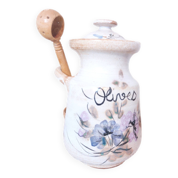 Old large vintage stoneware olive pot with its wooden spoon