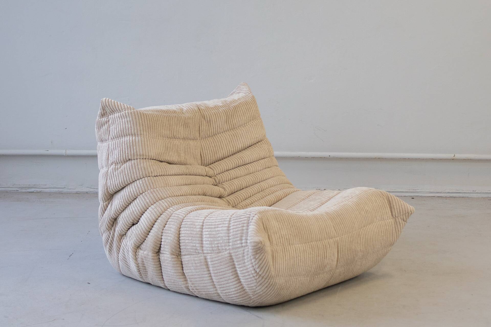 Togo set of 2 armchairs and poufne in beige corduroy