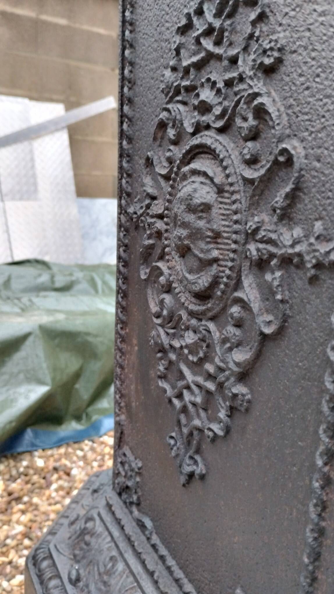 Black cast iron wood burning stove with solid brass handle.