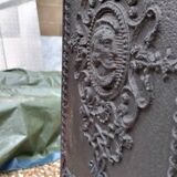 Black cast iron wood burning stove with solid brass handle.