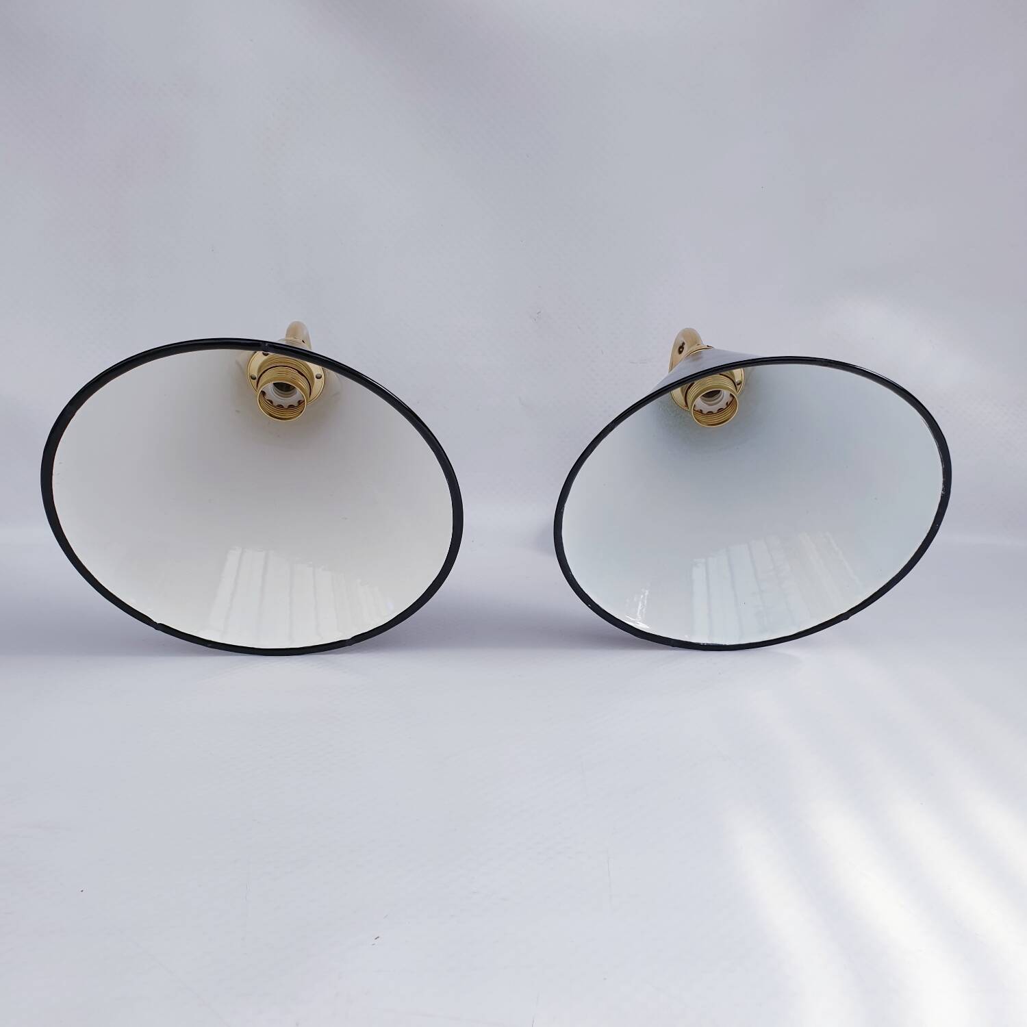 Pair of antique black enamelled sheet metal wall lights