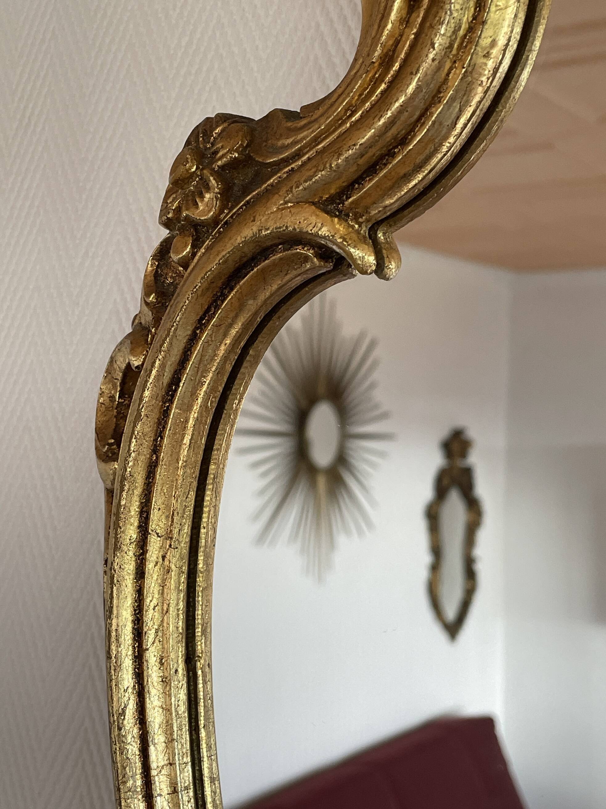 Old baroque style wall mirror with golden moldings