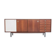 Wooden sideboard with sliding door and white drawers, around 1960.