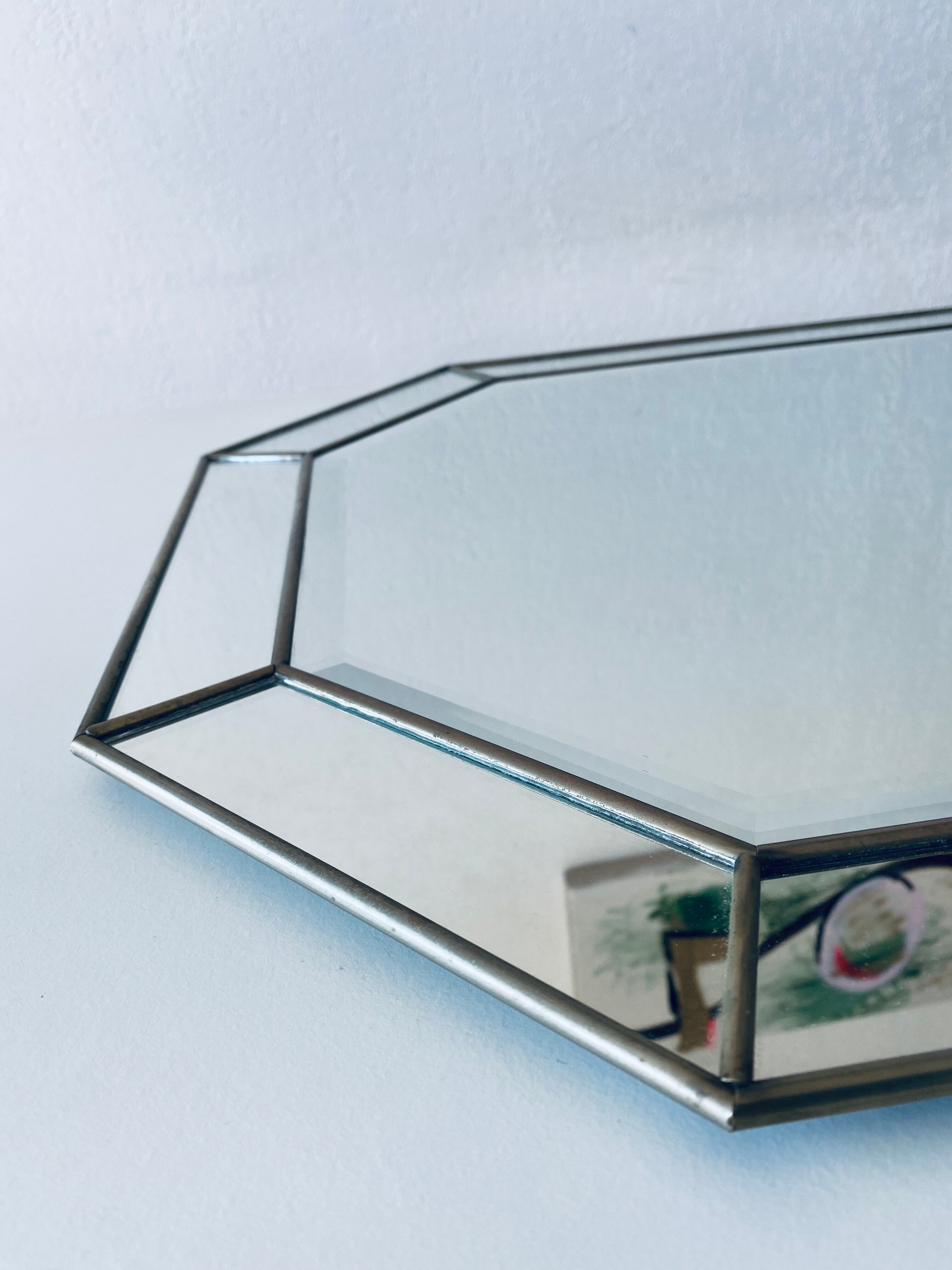 Old octagonal beveled mirror with parcloses