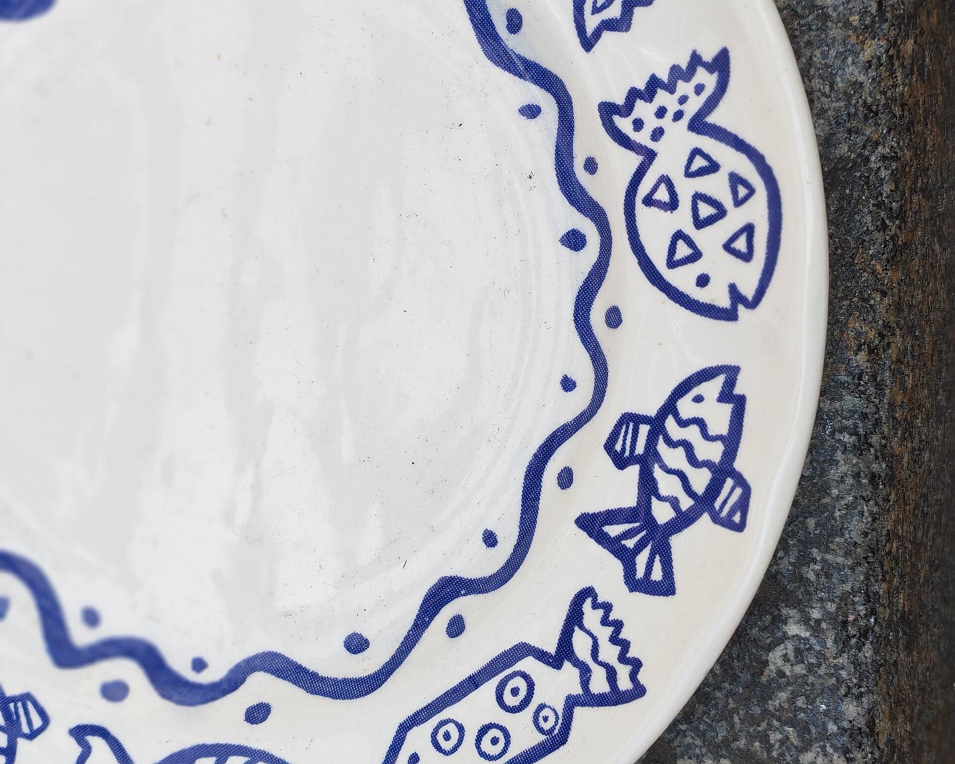 Pair of Castellania plates from Italy with blue fish decoration.