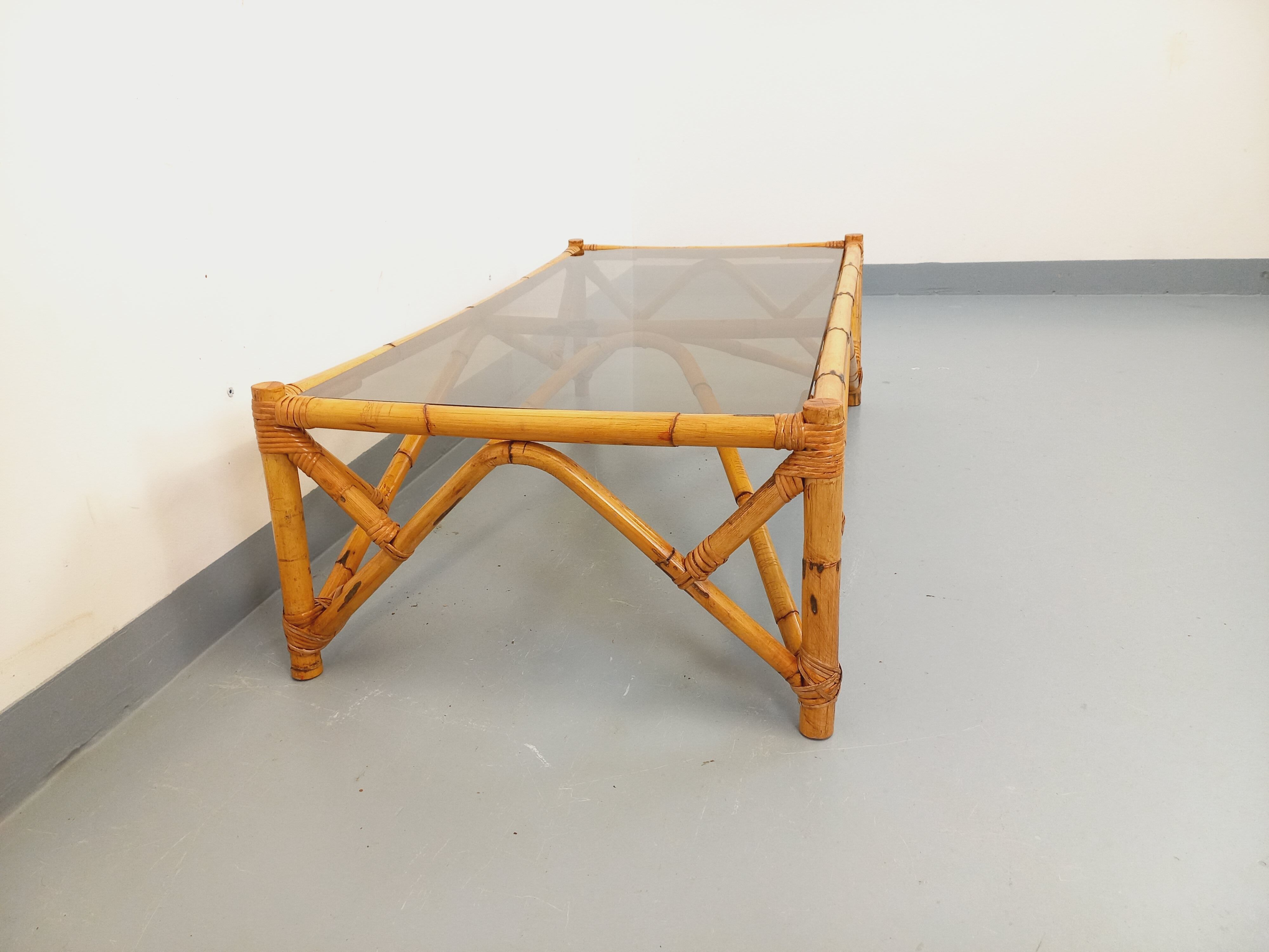 Vintage rectangular coffee table in rattan and smoked glass from the 1970s.