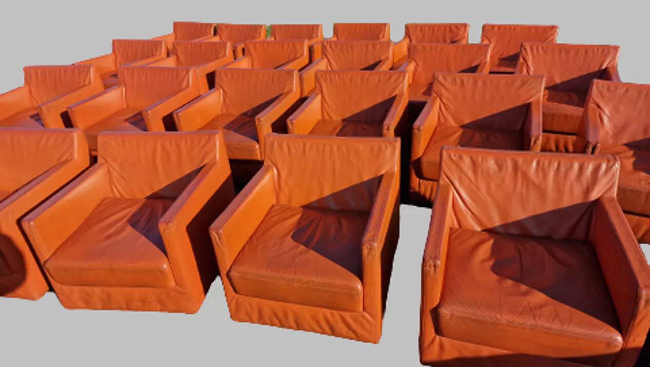 14 armchairs and 4 vintage orange leather benches