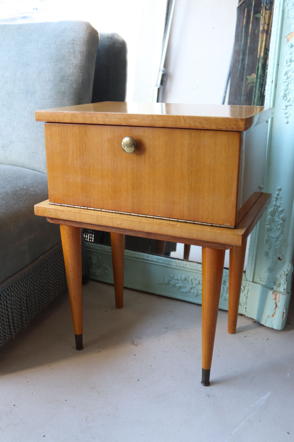 Modernist bedside table from the 1950s with compass legs.