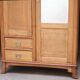 Art Nouveau wardrobe in blond wood with beveled mirror (circa 1909).