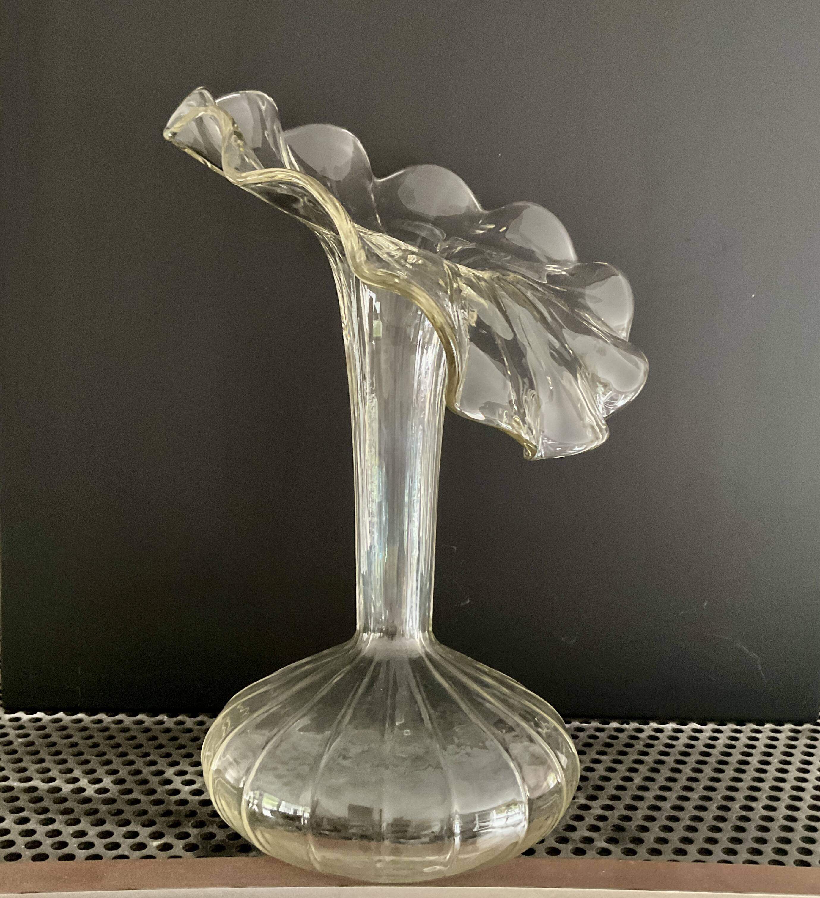 Vintage transparent glass vase in flower shape.