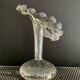 Vintage transparent glass vase in flower shape.