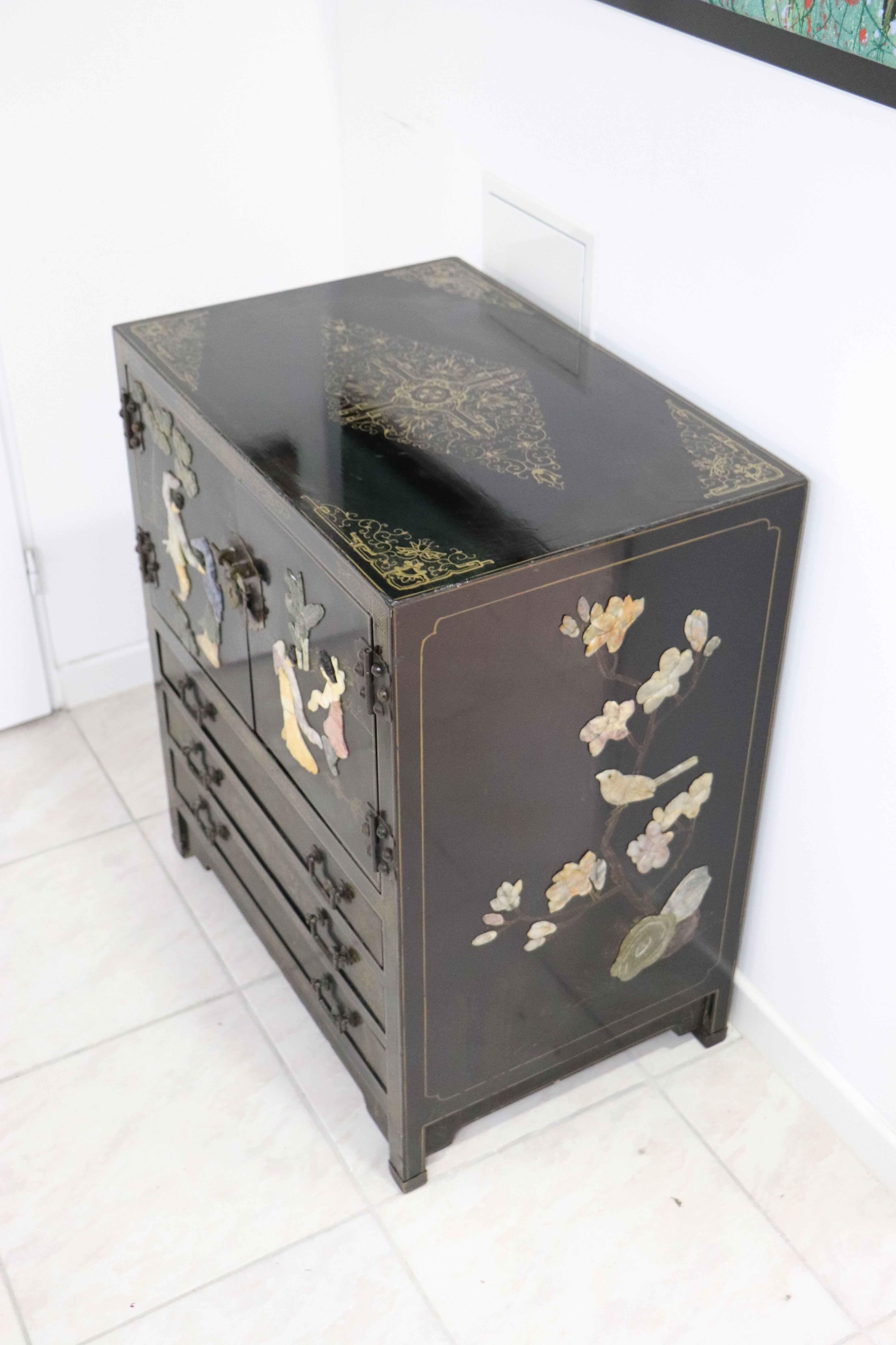 Black lacquered Chinese buffet with stone and ivory figures