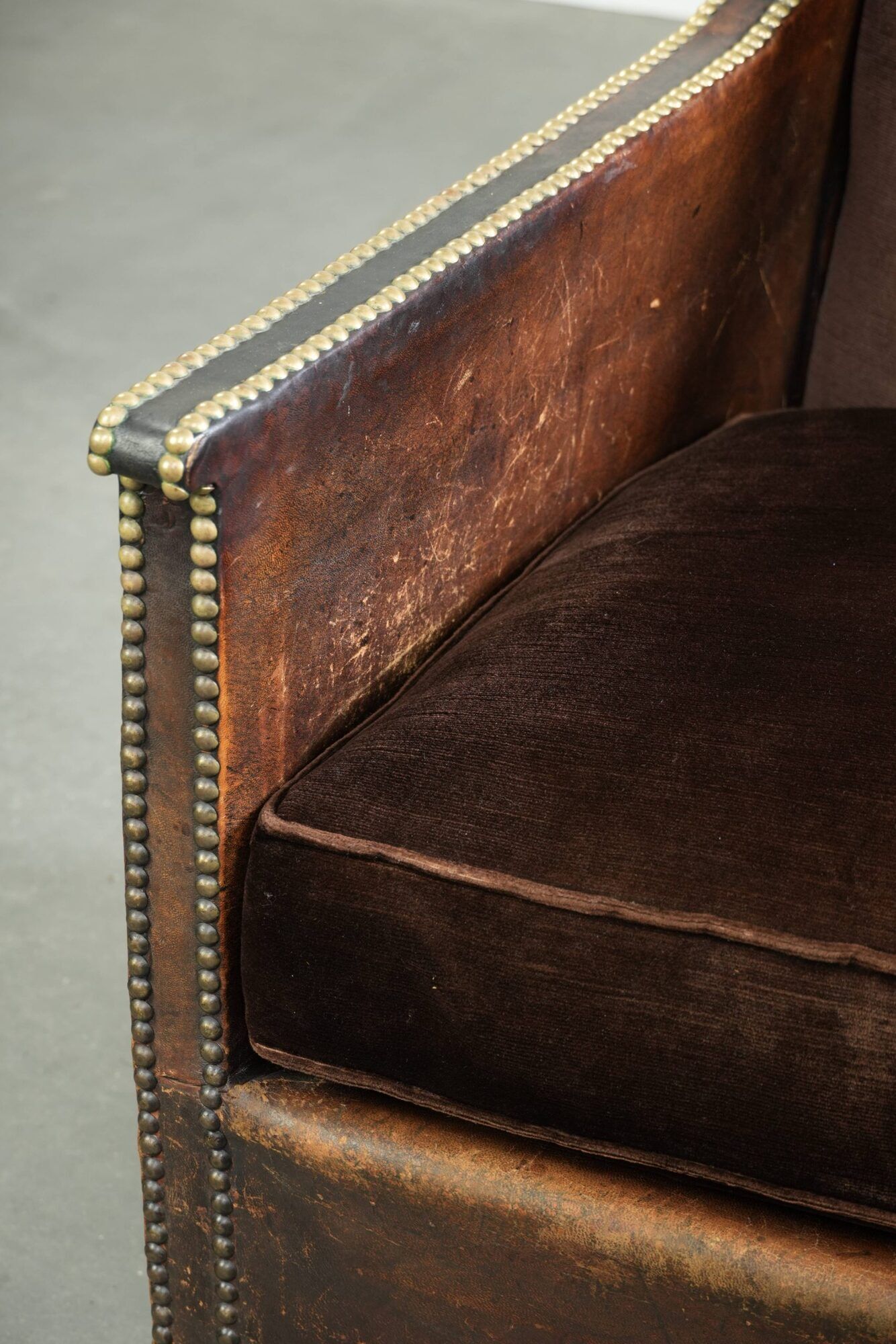 Art Deco design armchair finished in velvet and fitted with decorative nails