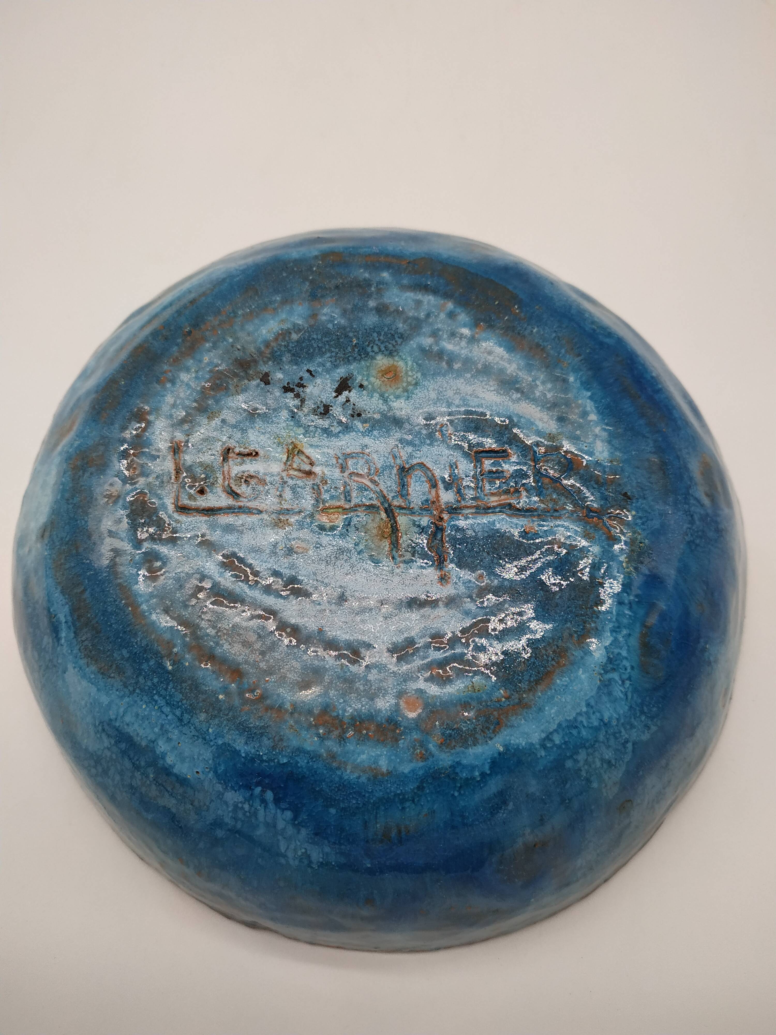 Hollow cut in blue enamelled sandstone decorated with yellow flowers