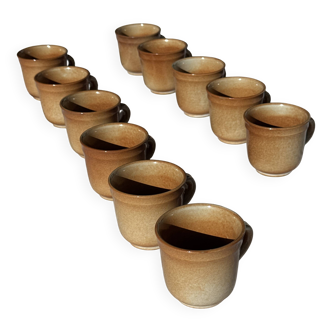 Set of 11 stoneware coffee mugs with handles.