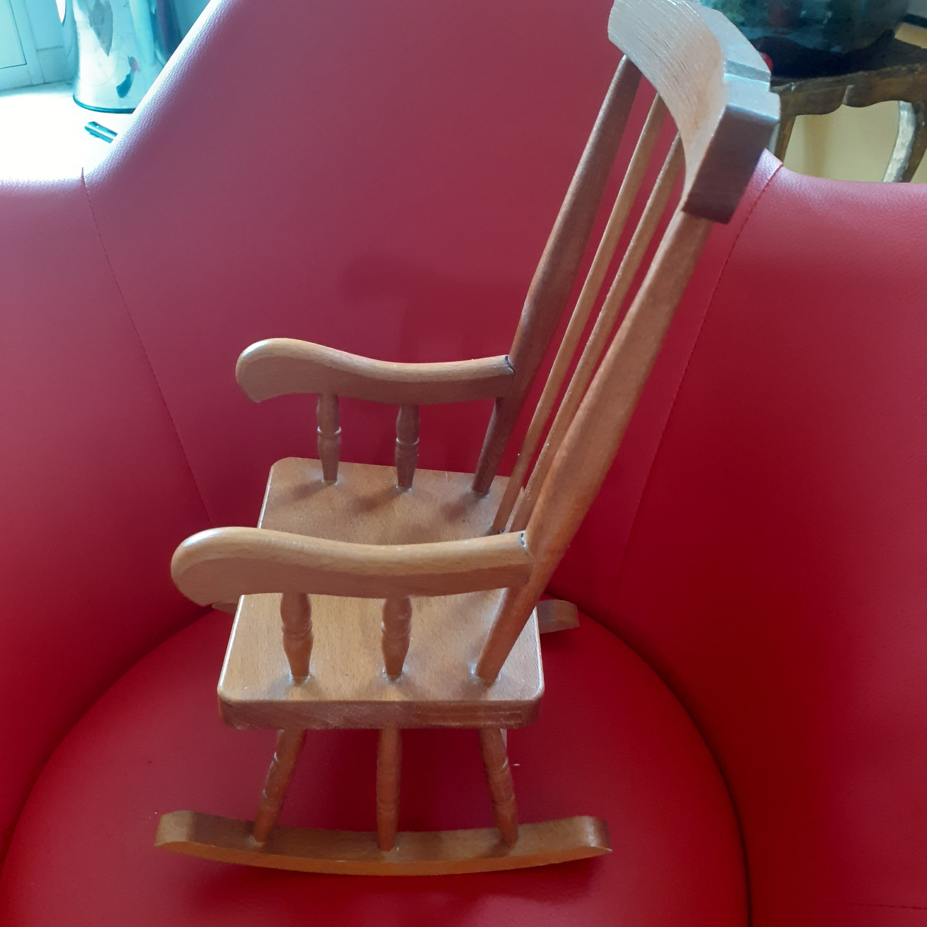 Toy wooden rocking chair.