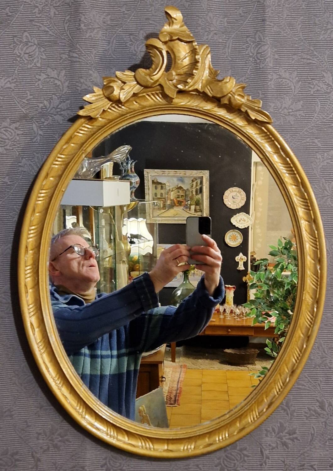 Golden oval mirror