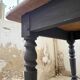 Oak farmhouse table with turned black legs.