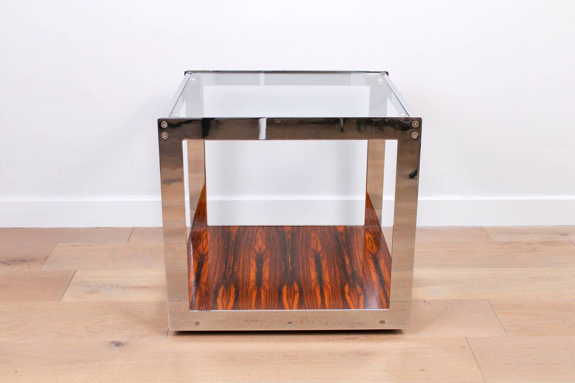 A vintage mid-century glass and rosewood side table by Merrow Associates