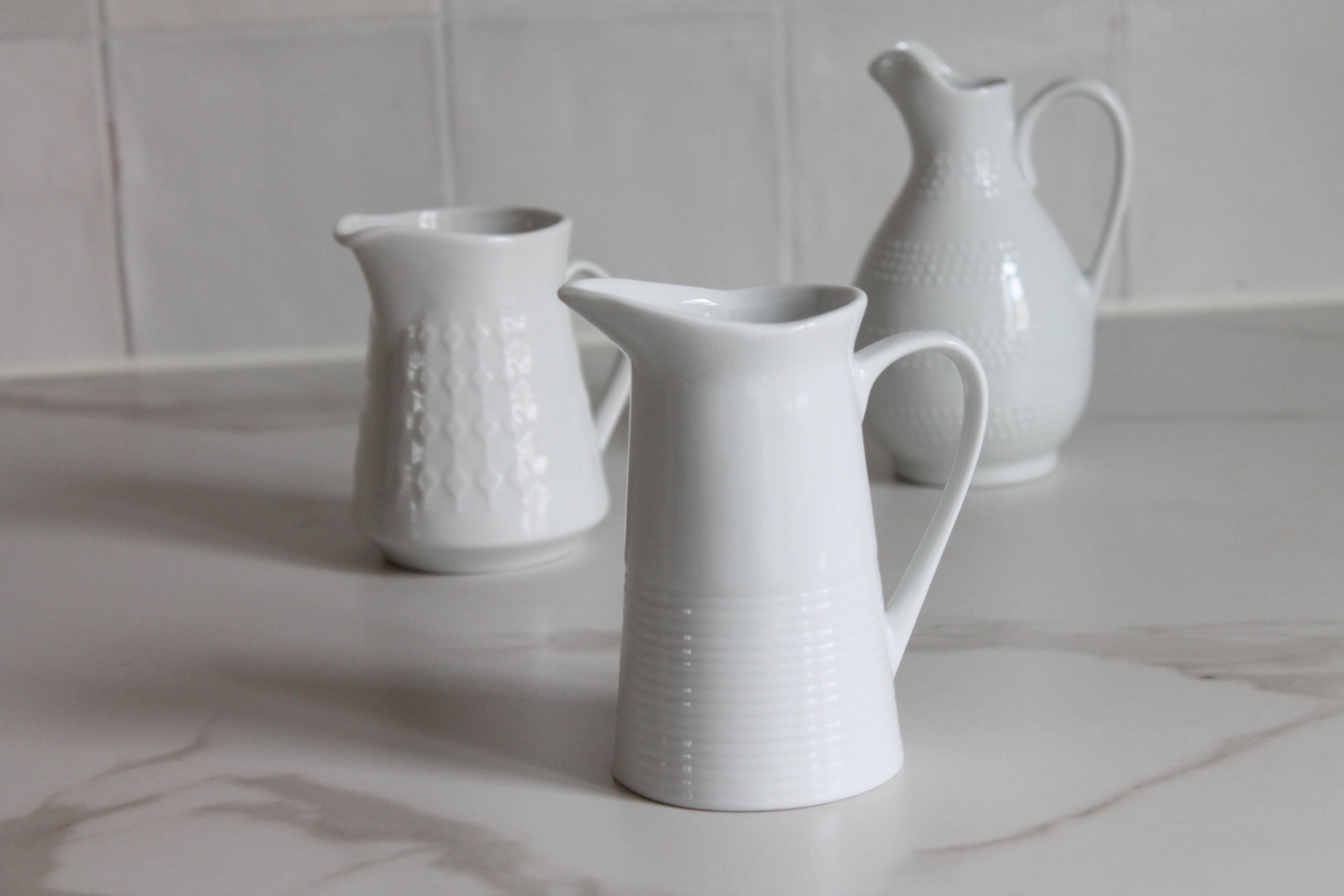 3 old French pitchers in white ceramic