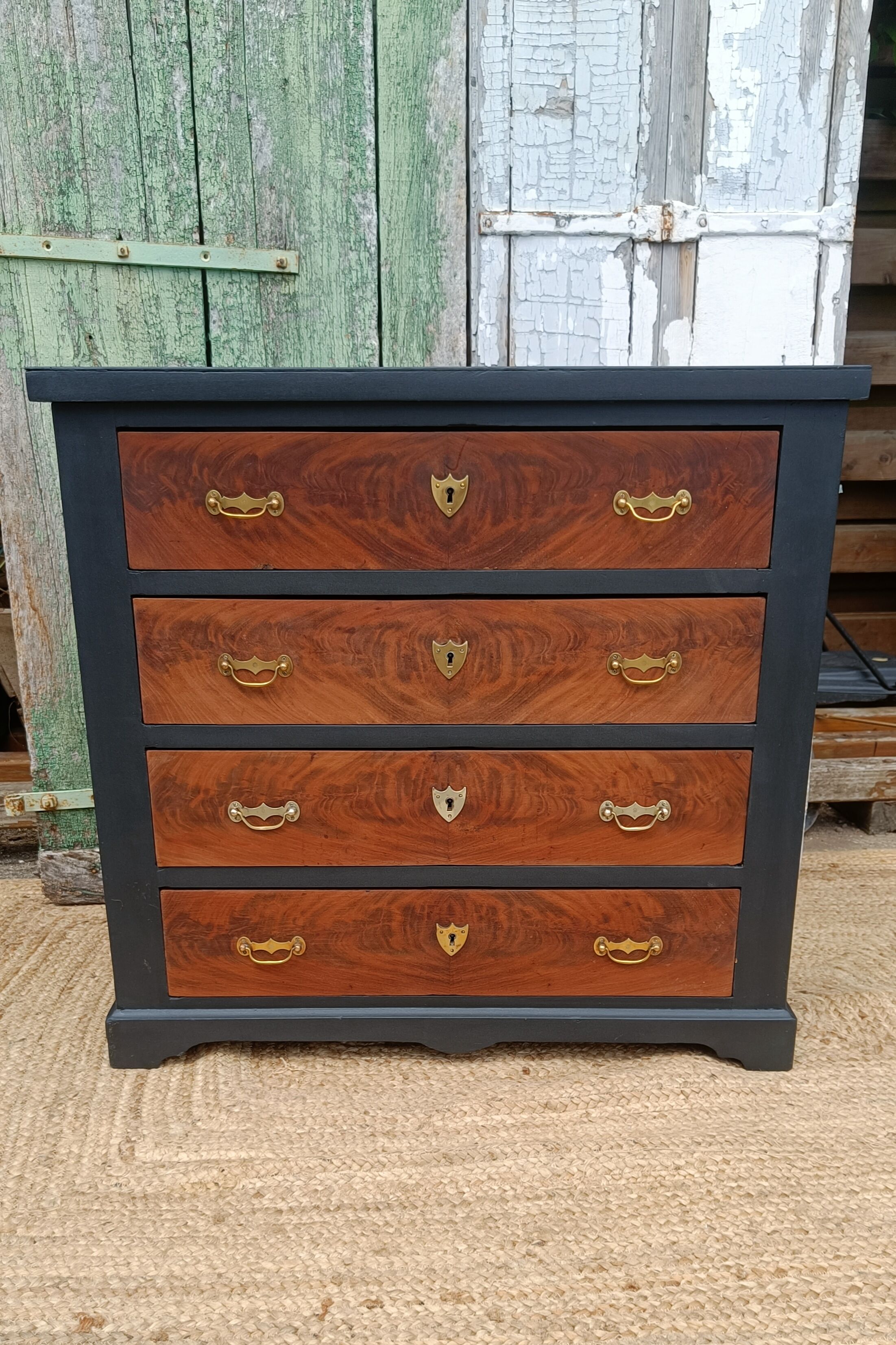 Vintage commode revamped in matte black & wood with warm tones.
