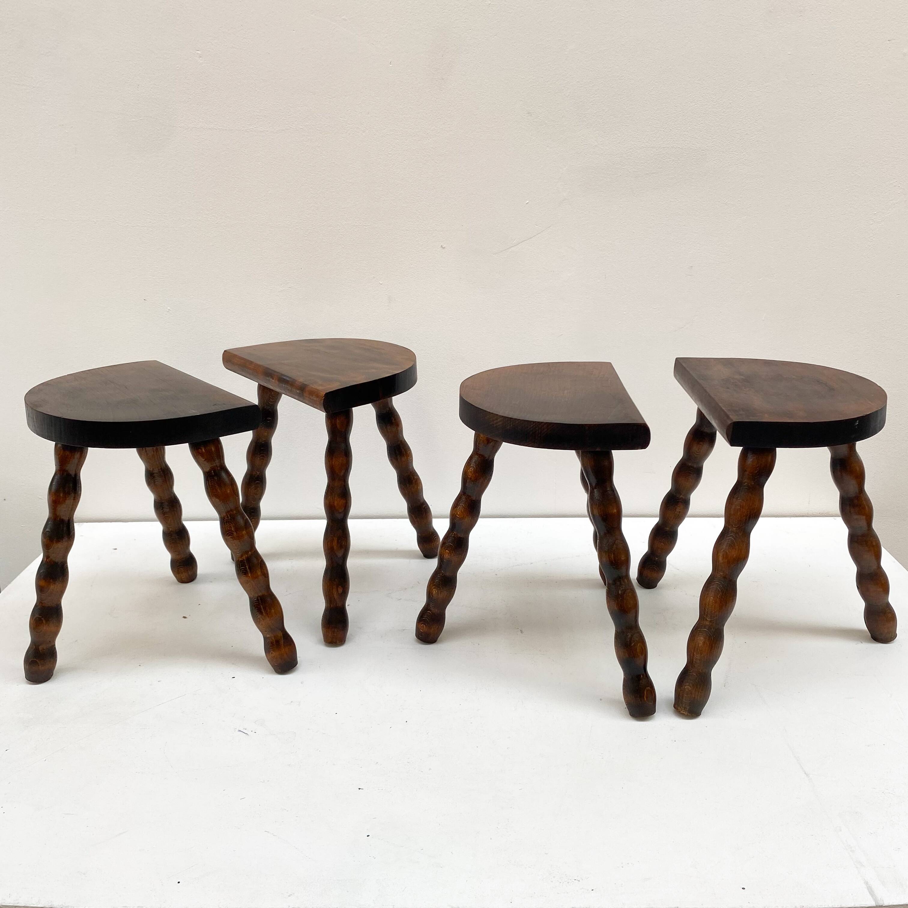 Series of 4 small tripod stools with half-moon seat and beaded turned wood legs