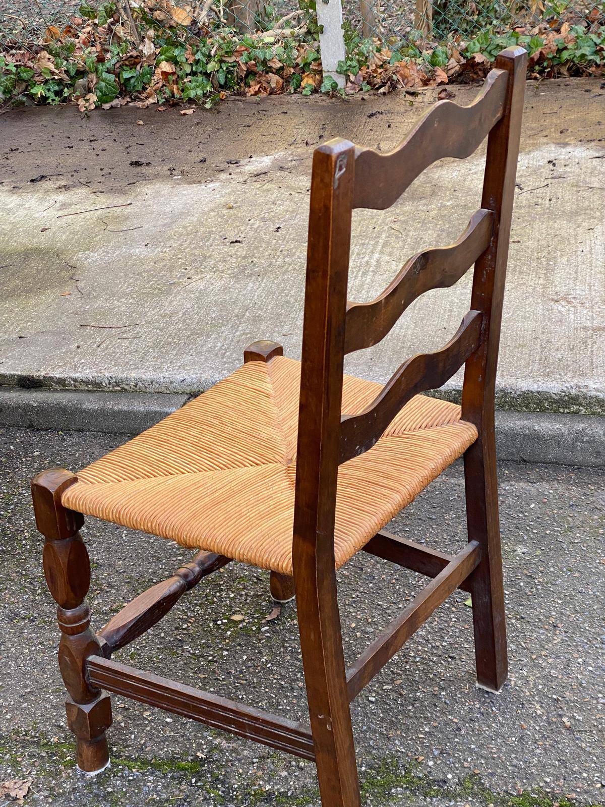 2 solid wood chairs with carved rush seats