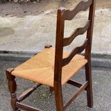 2 solid wood chairs with carved rush seats