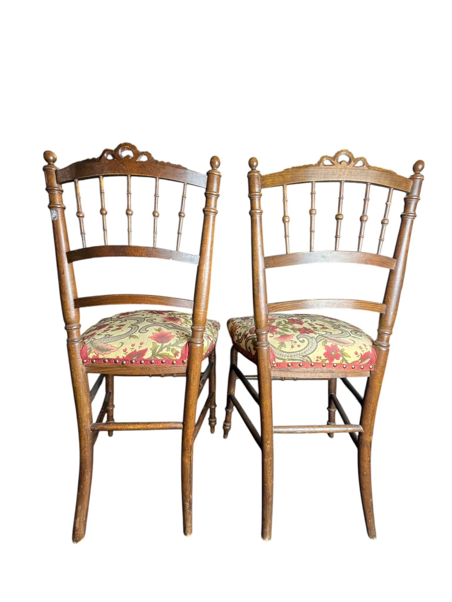Two floral upholstered music chairs from the early 20th century.