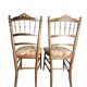Two floral upholstered music chairs from the early 20th century.